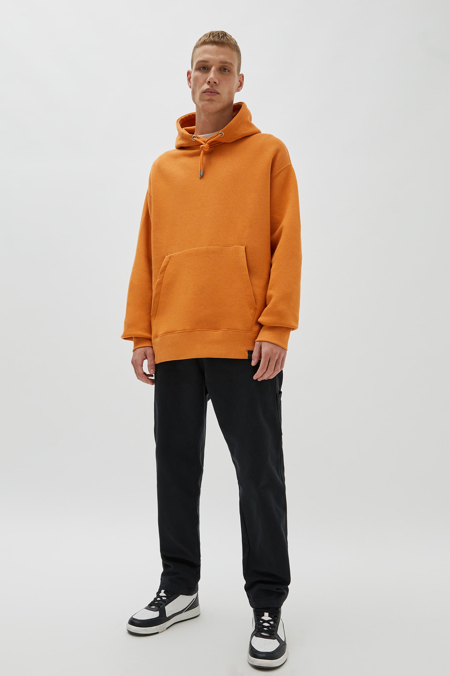 The Trendy Appeal of Pouch Pocket Hoodies in Vibrant Orange Hues